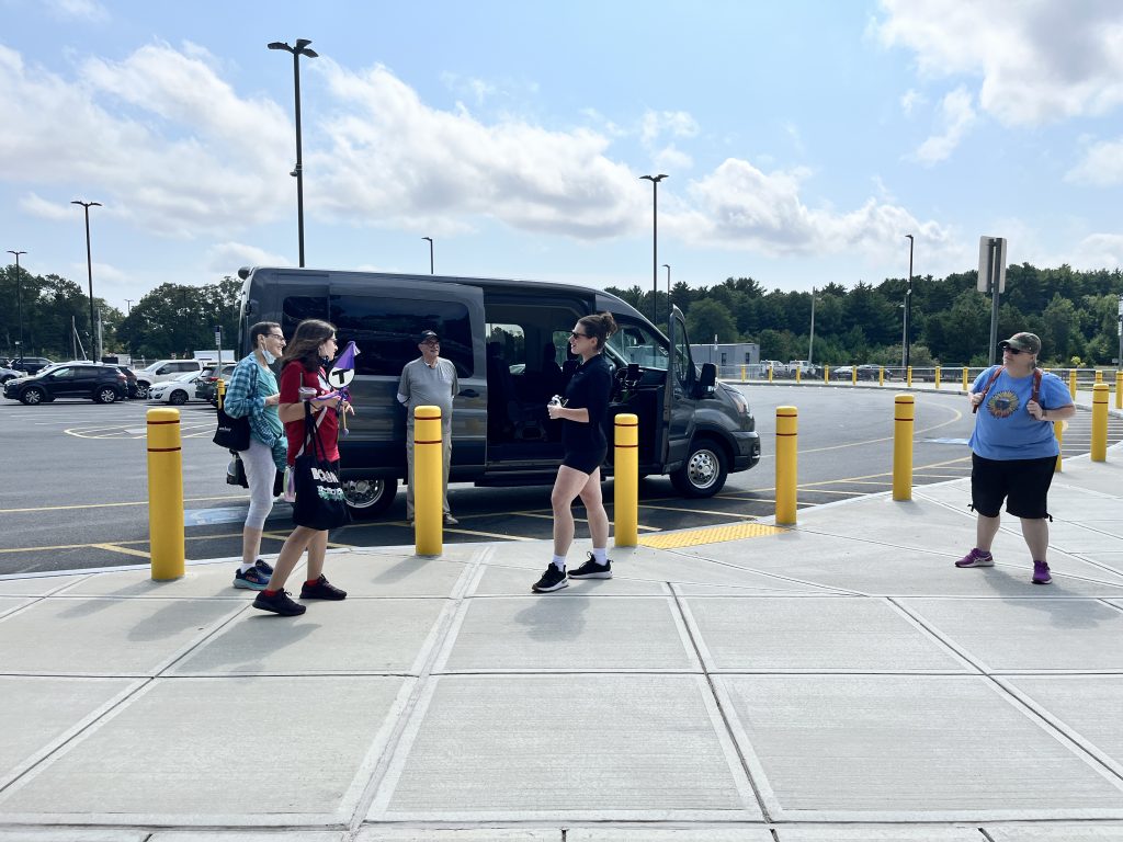 A group of tourists being picked up at the Middleboro MBTA station for a Keolis massAdventures tour to the Cranberry Bogs.