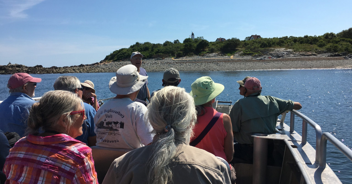 Group of people on a boat headed to Bakers Island, located the coast of Salem, Massachusetts