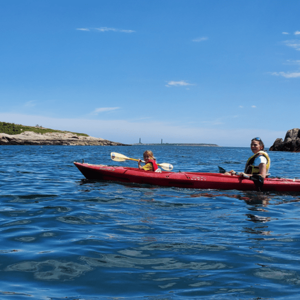 Woman and daughter kayaking in the water off Rockport, Massachusetts