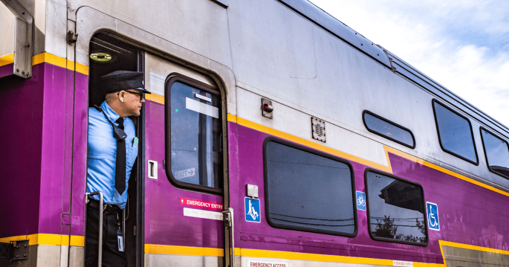 An MBTA Commuter Rail Conductor looking out from the train 