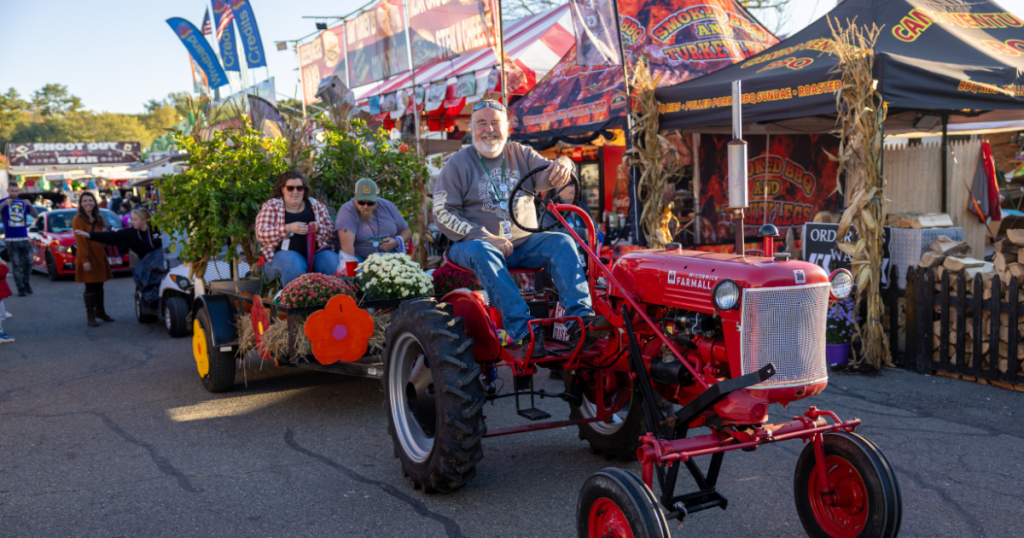 Man driving a tractor at the Topsfield Fair in Topsfield, Massachusetts., the oldest agricultural fair in the United States and an annual New England fall tradition.