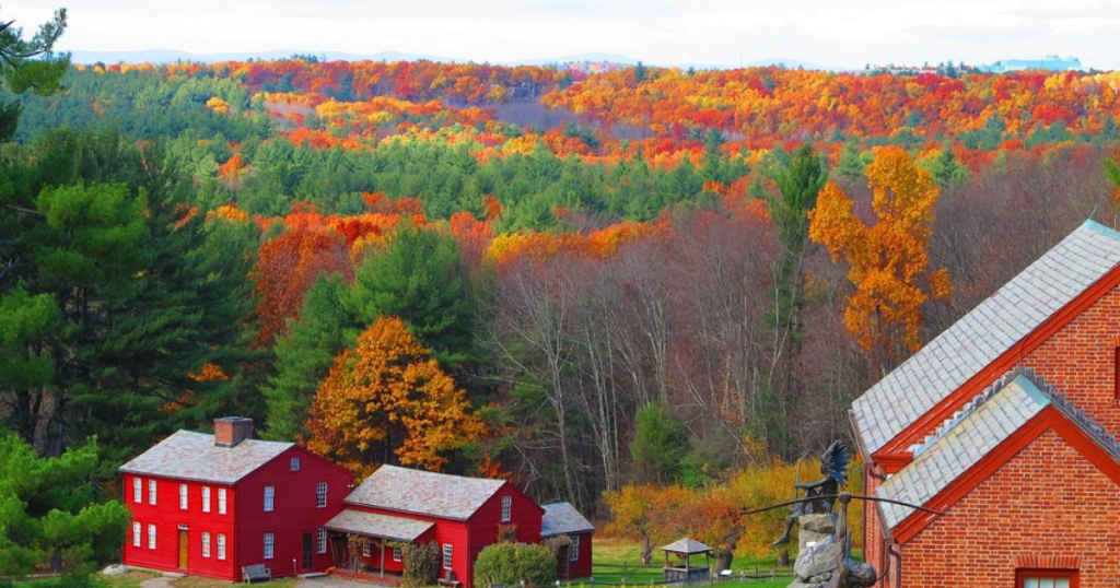 The Fruitlands Museum in Harvard, Massachusetts showcasing a stunning backdrop of colorful fall foliage.