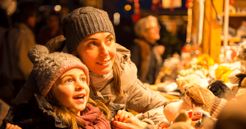 Mother and daughter looking at toys at a Christmas market in Boston