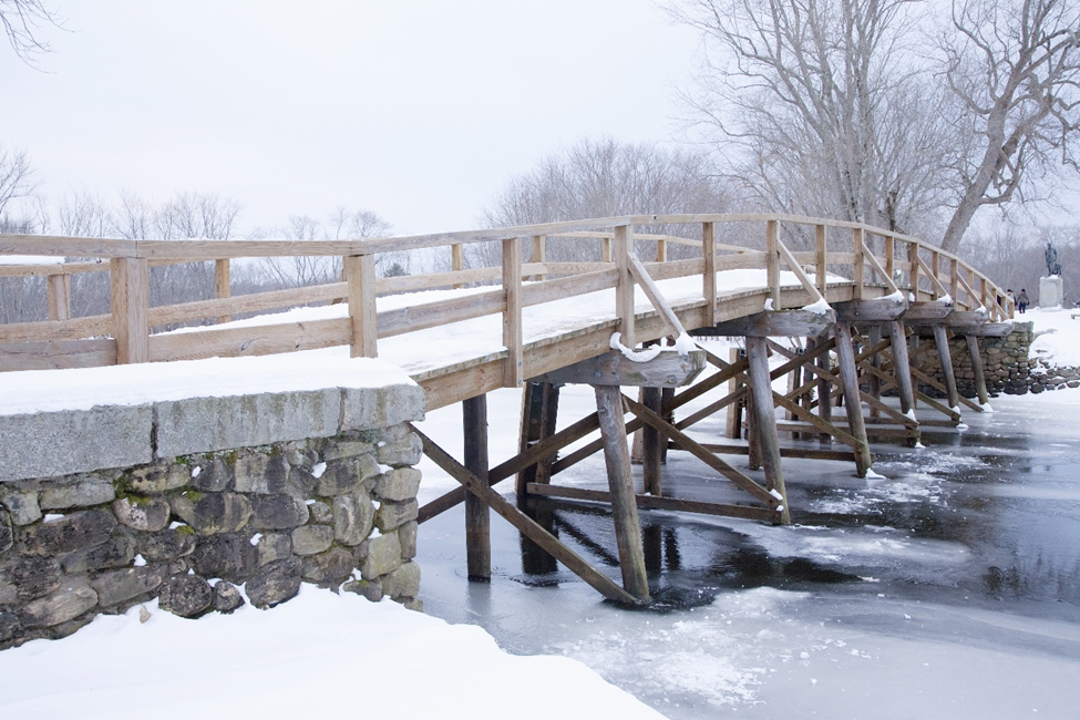   Old North Bridge in Concord surrounded by snow and frost during winter