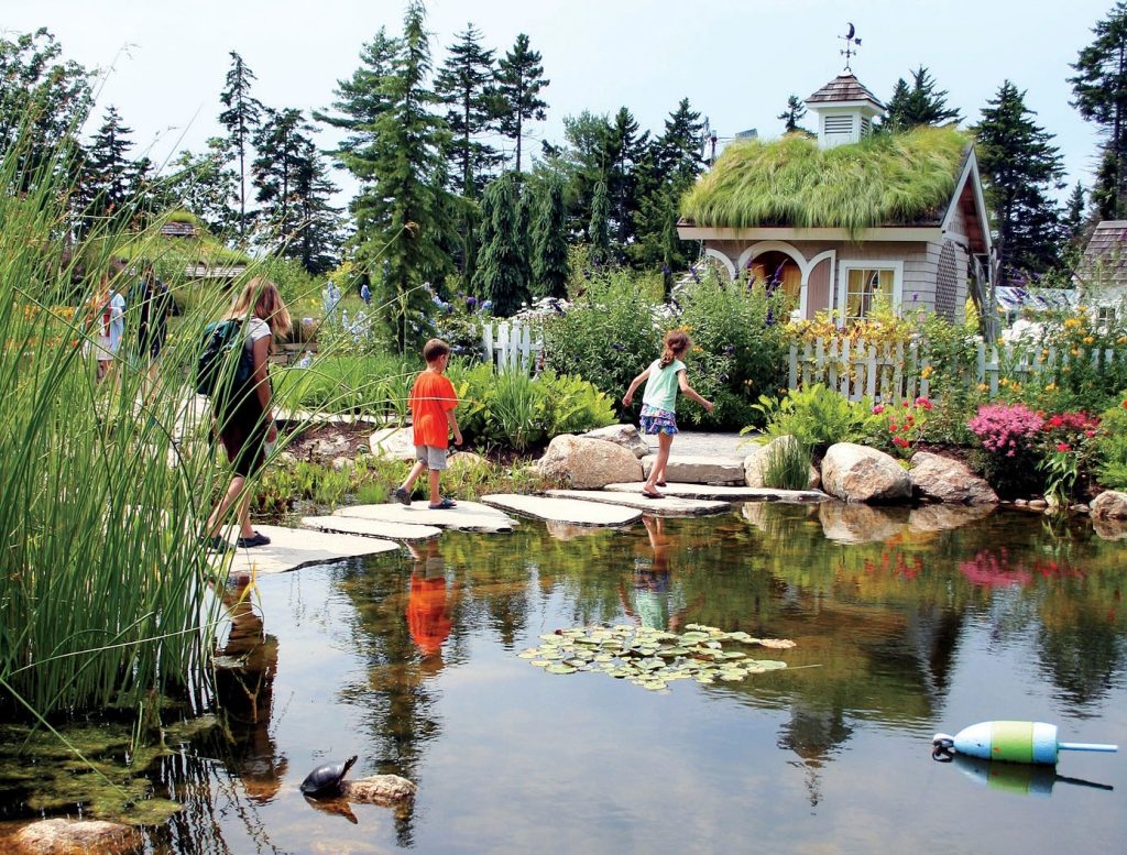 kids skipping across a pond at the New England Botanic Gardens at Tower Hill