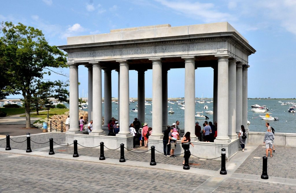 visitors looking at Plymouth rock in Plymouth Massachusetts during the summer