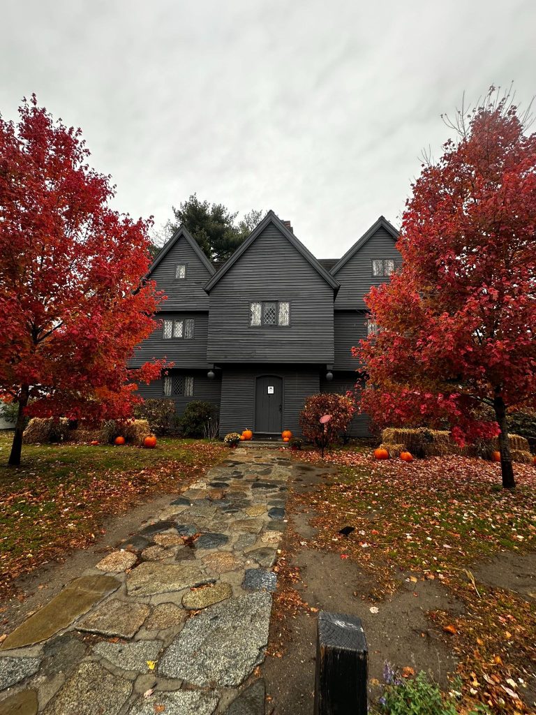 House of the seven gables in Salem, MA in October with fall foliage and decorated for halloween.