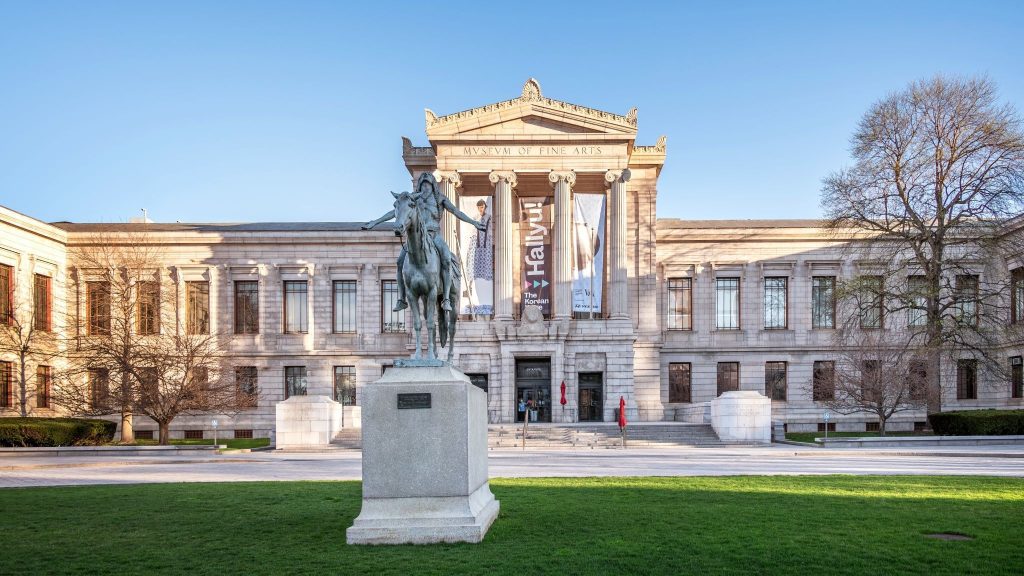Front view of the Boston Museum of Fine Arts in the afternoon as the sun is setting