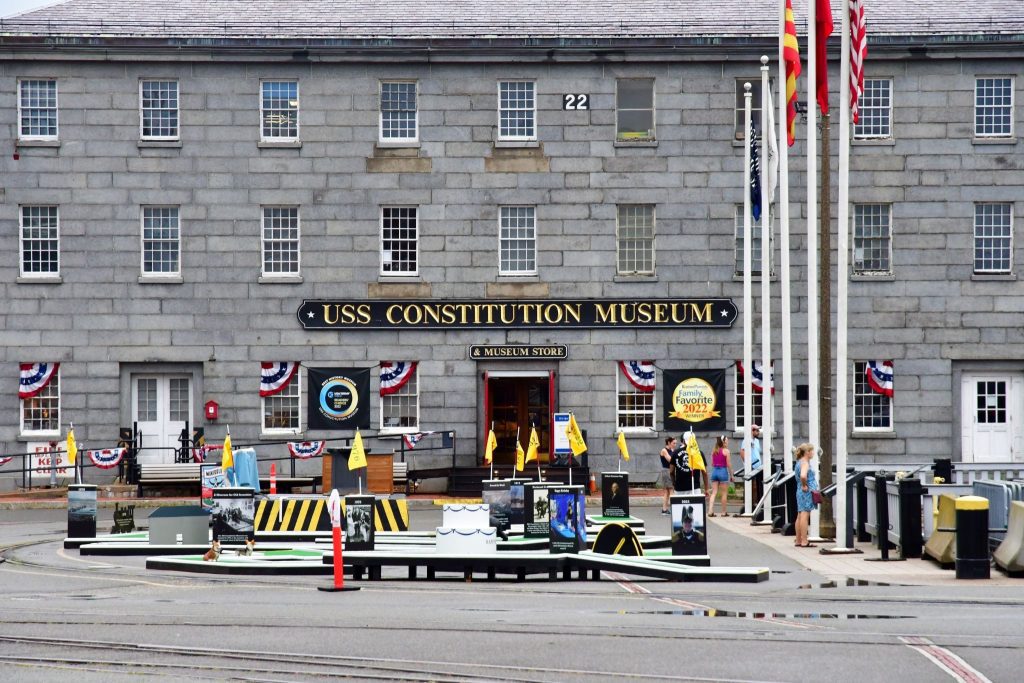 Front view of the USS Constitution Museum in Boston, MA with American flags